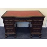 A mahogany nine drawer carved sideboard with leath