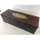 A rectangular rosewood musical box with glazed int