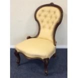 An Edwardian button back nursing chair on cabriole