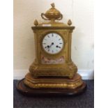 A brass mounted French clock with cherub decoratio