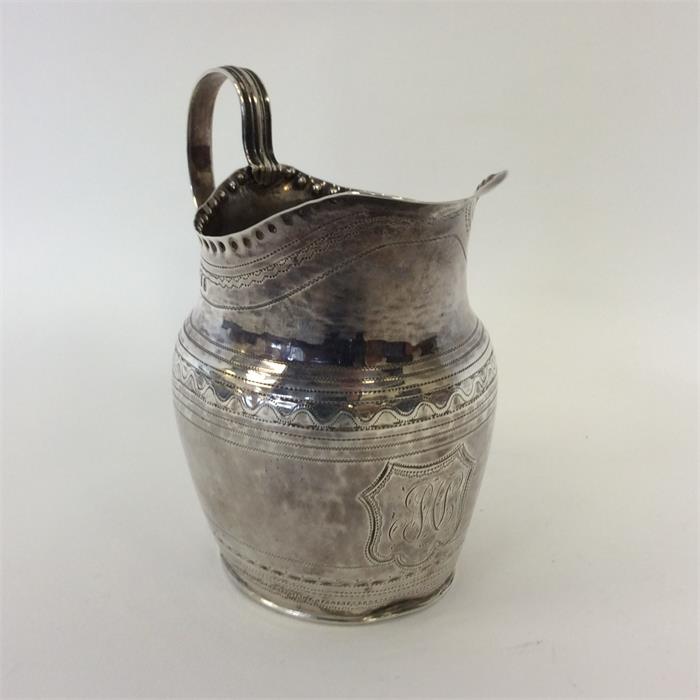 A Georgian oval cream jug with reeded bright cut d - Image 2 of 2