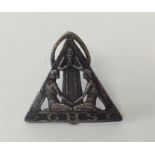 An Art Nouveau badge in the form of two praying wo