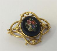 A stylish micro-mosaic brooch in the form of flowe