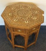 An Eastern ivory inlaid table decorated with flowe
