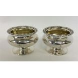 A pair of large silver salts with gilt interiors a