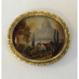 An oval miniature of an alpine scene in engraved f