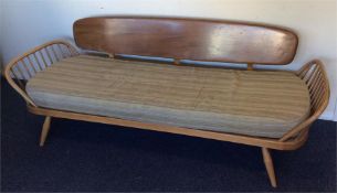 ERCOL: A spindle sided day bed with back support.