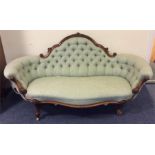 A mid-Victorian scroll ended sofa on cabriole legs