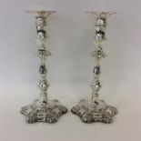 A good pair of tall candlesticks attractively deco