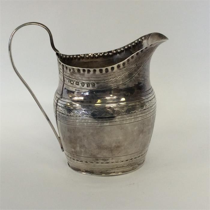 A Georgian oval cream jug with reeded bright cut d