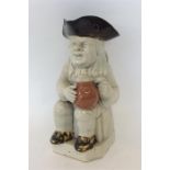 An Antique Toby jug on square base. Approx. 25 cms