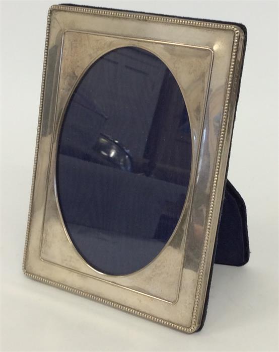 A small rectangular modern picture frame with bead