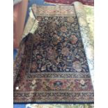 A large tapestry carpet. Est. £100 - £150.