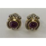 A pair of stylish cabochon ruby and diamond cluste