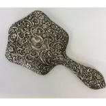 An embossed hand mirror profusely decorated with f