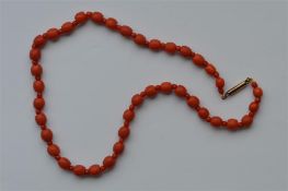 A good graduated string of coral beads with gold c