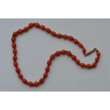 A good graduated string of coral beads with gold c