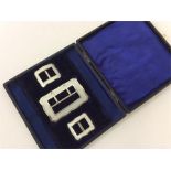 A boxed set of three enamelled buckles. Birmingham