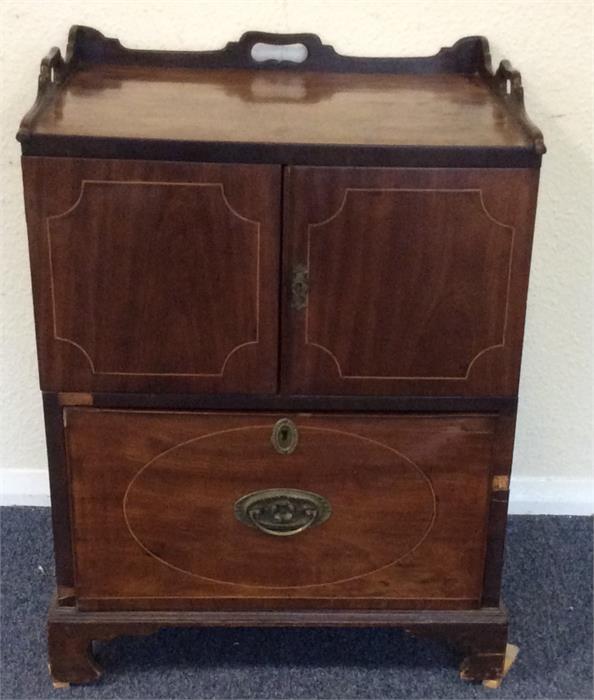 A Georgian two door commode with brass handles and