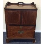 A Georgian two door commode with brass handles and