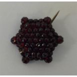 An Antique garnet brooch in the form of a star. Ap