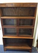 A stylish oak four stack bookcase with glazed door