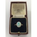 An oval opal and diamond Edwardian cluster ring in