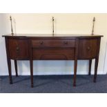 A Georgian two door bow front sideboard with brass