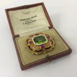 A good quality peridot, ruby and enamel brooch in