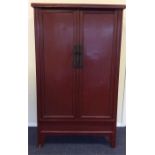 A 19th Century red lacquered tall cabinet with fit
