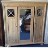 A good pine two door triple wardrobe with moulded