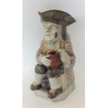 A large Antique Toby jug on square base. Est. £20