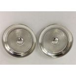 A pair of modern engine turned silver ashtrays. Ap