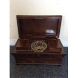 A mahogany hinged top tea caddy with fitted interi