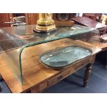 A large glass occasional table with reeded decorat