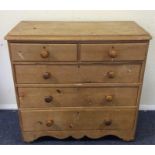 A pine five drawer chest with turned handles and w