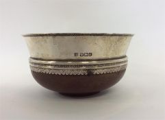 A silver and wooden mounted mazer cup with engrave