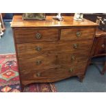 A mahogany flat front chest of drawers on splay fe