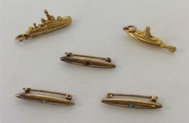 A small gold fob in the form of a submarine togeth