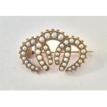 An oval 15 carat triple horseshoe and pearl brooch