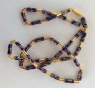 An unusual string of enamelled beads with barrel c