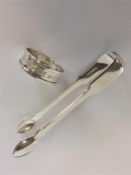 A pair of heavy fiddle patterned sugar tongs toget