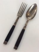 An unusual pair of folding cutlery with ebony hand