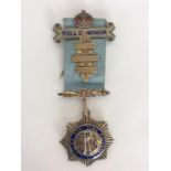 A silver and enamelled Roll of Honour medal on blu