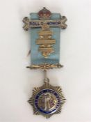 A silver and enamelled Roll of Honour medal on blu