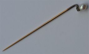 A small gold and pearl (untested) stick pin mounte