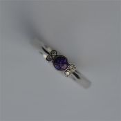 An amethyst and diamond four stone ring in white g