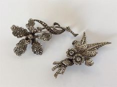 A silver and marcasite brooch in the form of a flo