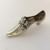 An unusual pin cushion in the form of a shoe with