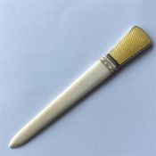 An unusual enamel and carved ivory paper knife of